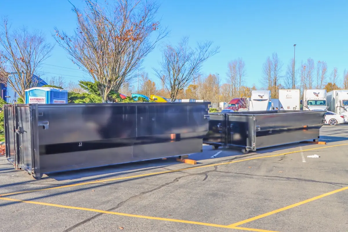 Professional dumpster rental service with roll-off container on residential driveway in Canyon Lake